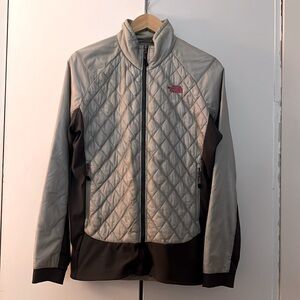Silver and grey The North Face mid level jacket - figure flattering.